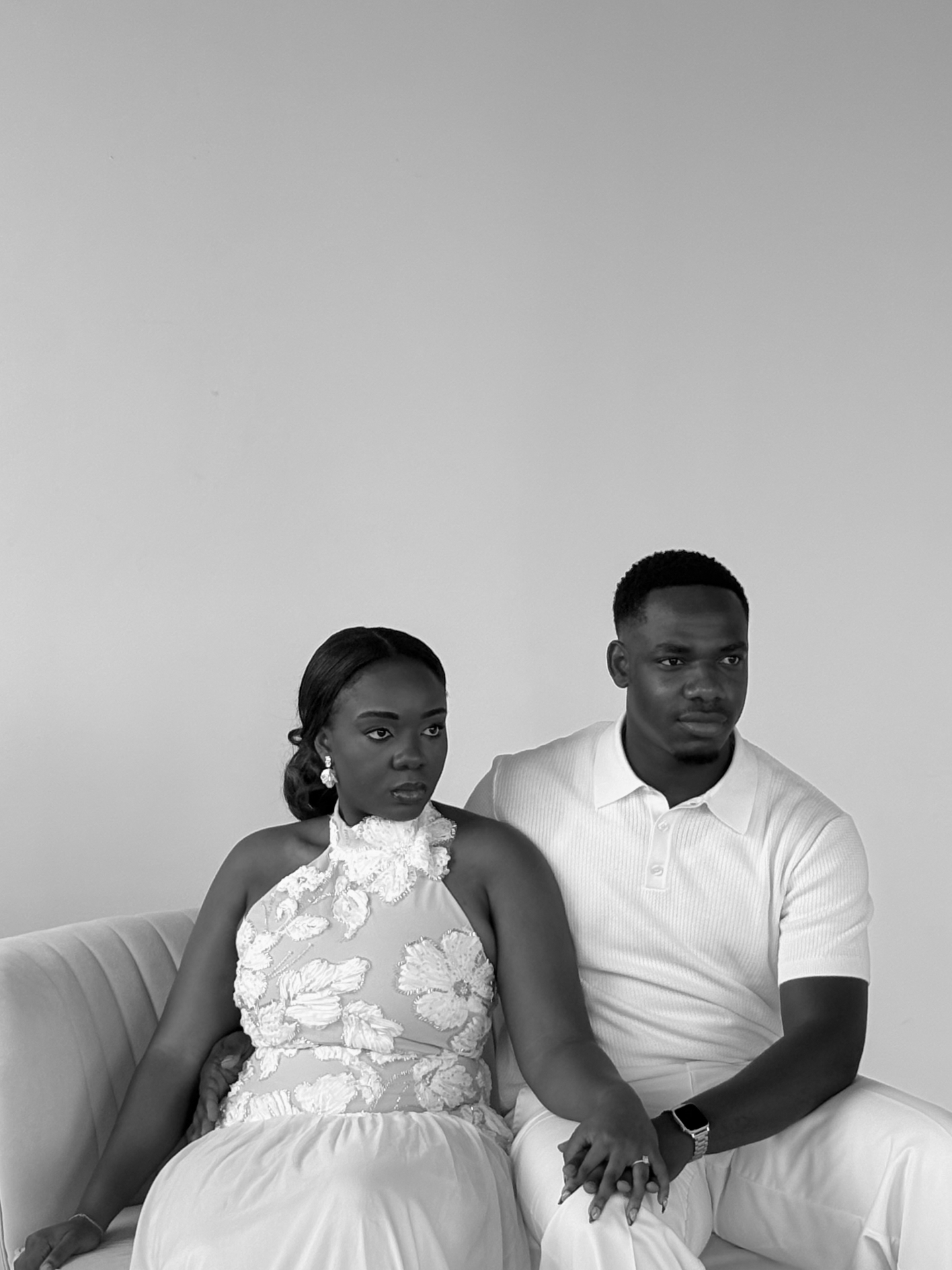 Riziane and Lael seated together in white